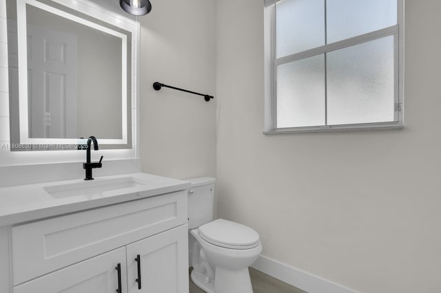 4123 Parkside Dr, Jupiter, FL 33458 - half bath featuring toilet, vanity, and baseboards