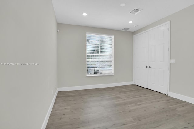 4123 Parkside Dr, Jupiter, FL 33458 - unfurnished bedroom featuring baseboards, wood finished floors, a closet, and recessed lighting