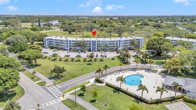 2002 Lyndhurst H Unit 2002, Deerfield Beach, FL 33442 - aerial view of apartment complex / building, a pool, and a tree filled landscape