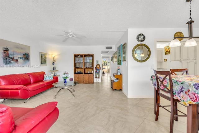 2002 Lyndhurst H Unit 2002, Deerfield Beach, FL 33442 - living area featuring a textured ceiling and ceiling fan