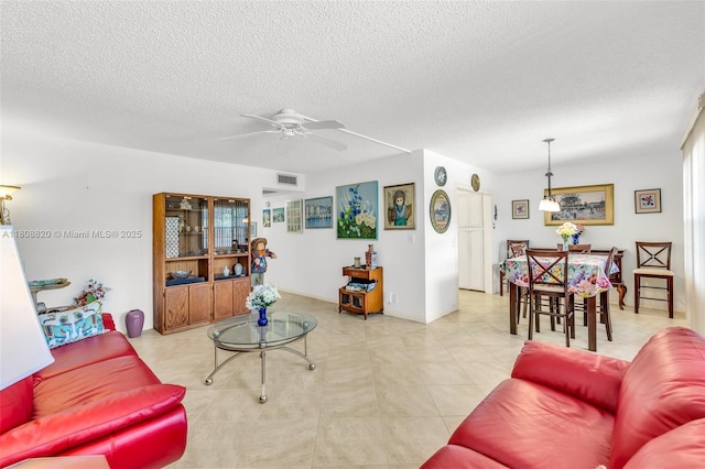 2002 Lyndhurst H Unit 2002, Deerfield Beach, FL 33442 - living room with a ceiling fan and a textured ceiling