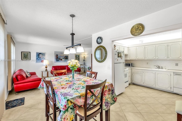2002 Lyndhurst H Unit 2002, Deerfield Beach, FL 33442 - dining area featuring light tile patterned flooring and a textured ceiling