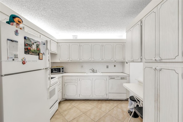 2002 Lyndhurst H Unit 2002, Deerfield Beach, FL 33442 - kitchen with white appliances, a sink, light countertops, a textured ceiling, and light tile patterned floors