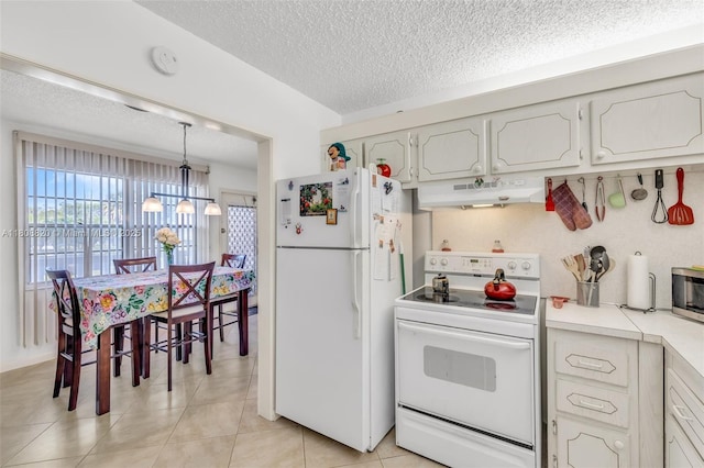 2002 Lyndhurst H Unit 2002, Deerfield Beach, FL 33442 - kitchen featuring white appliances, under cabinet range hood, a textured ceiling, light countertops, and a chandelier