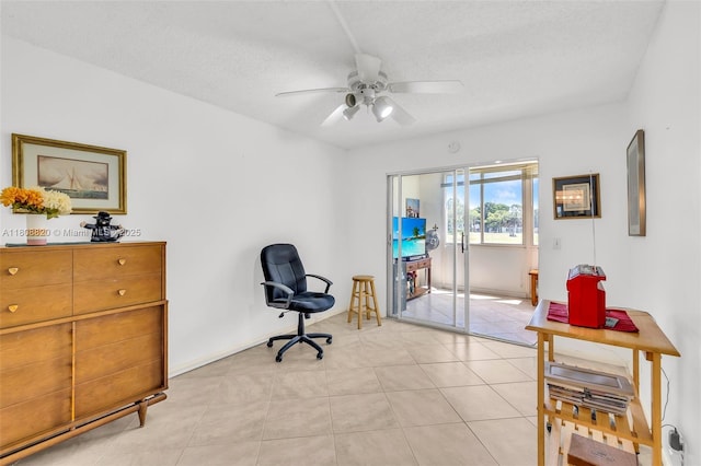 2002 Lyndhurst H Unit 2002, Deerfield Beach, FL 33442 - living area featuring ceiling fan, light tile patterned flooring, and a textured ceiling