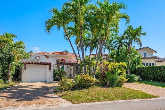 425 N Shore Dr, Miami Beach, FL 33141 - mediterranean / spanish-style home with a garage, decorative driveway, stucco siding, and a tiled roof