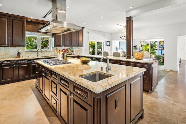 425 N Shore Dr, Miami Beach, FL 33141 - kitchen featuring a sink, stainless steel gas stovetop, island exhaust hood, a center island with sink, and healthy amount of natural light