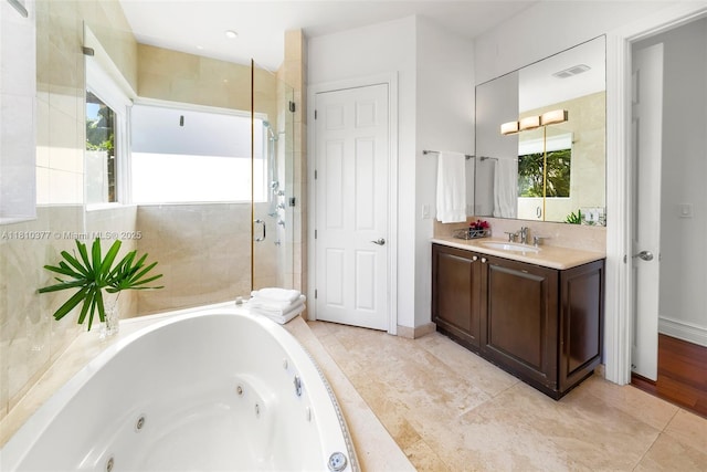 425 N Shore Dr, Miami Beach, FL 33141 - full bathroom with a whirlpool tub, vanity, a shower stall, tile patterned floors, and baseboards