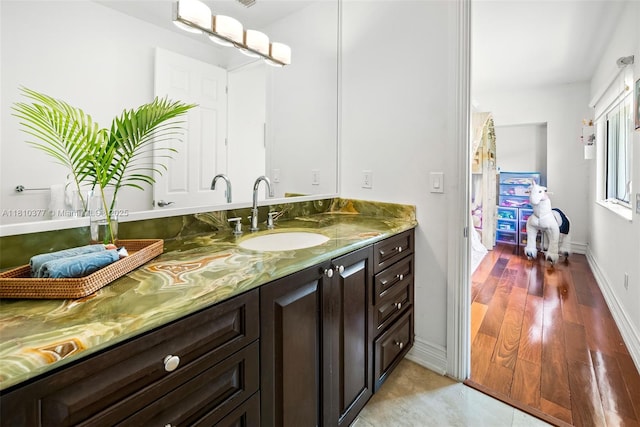 425 N Shore Dr, Miami Beach, FL 33141 - bathroom with vanity, baseboards, and wood finished floors