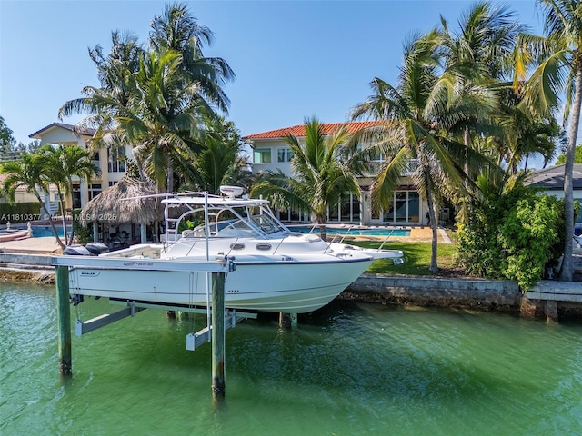 425 N Shore Dr, Miami Beach, FL 33141 - dock area featuring boat lift, a water view, and an outdoor pool