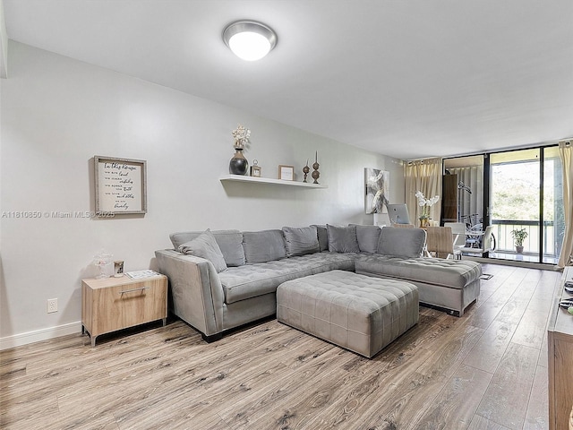 8411 Forest Hills Dr Unit 307, Coral Springs, FL 33065 - living room with light wood-style flooring, floor to ceiling windows, and baseboards