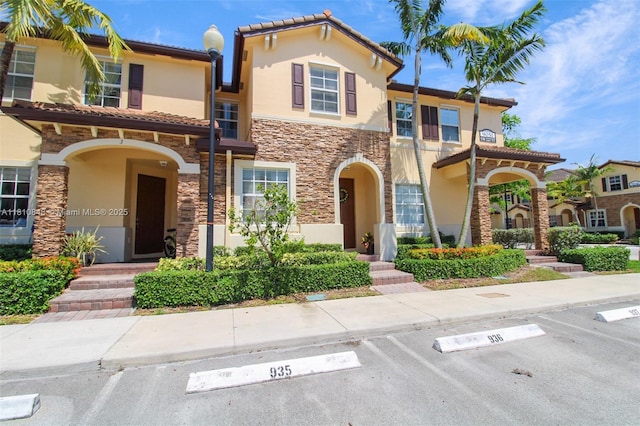 9051 SW 227th St Unit 2, Cutler Bay, FL 33190 - view of front of home featuring stone siding, stucco siding, uncovered parking, and a tiled roof