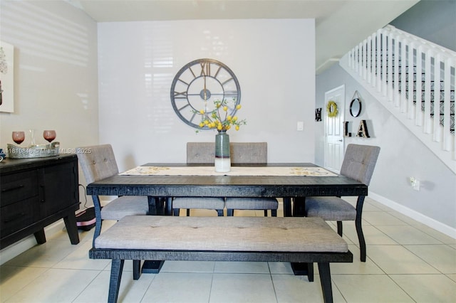 9051 SW 227th St Unit 2, Cutler Bay, FL 33190 - dining area featuring light tile patterned flooring, baseboards, and stairway