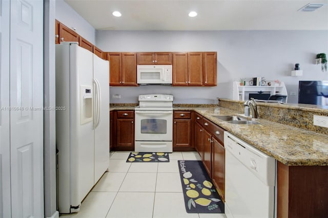 9051 SW 227th St Unit 2, Cutler Bay, FL 33190 - kitchen featuring white appliances, a sink, a peninsula, light stone countertops, and light tile patterned flooring