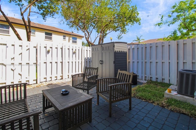 9051 SW 227th St Unit 2, Cutler Bay, FL 33190 - fenced backyard featuring a patio area, central air condition unit, and an outdoor hangout area