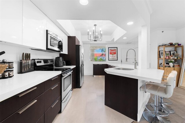 3245 NE 184th St Unit 13402, Aventura, FL 33160 - kitchen with appliances with stainless steel finishes, modern cabinets, a sink, a kitchen breakfast bar, and recessed lighting