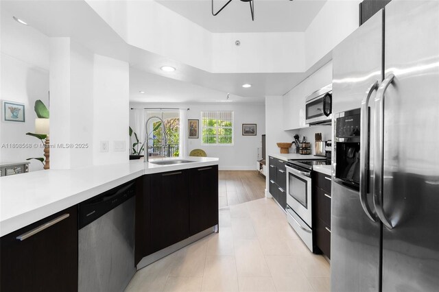 3245 NE 184th St Unit 13402, Aventura, FL 33160 - kitchen featuring appliances with stainless steel finishes, a sink, light countertops, modern cabinets, and recessed lighting