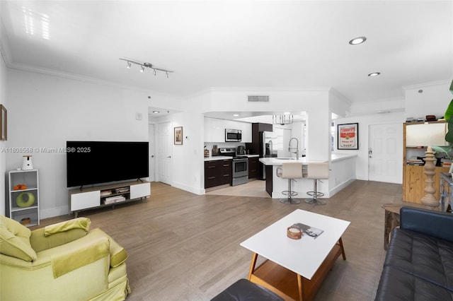 3245 NE 184th St Unit 13402, Aventura, FL 33160 - living room with ornamental molding, light wood-style floors, baseboards, and recessed lighting