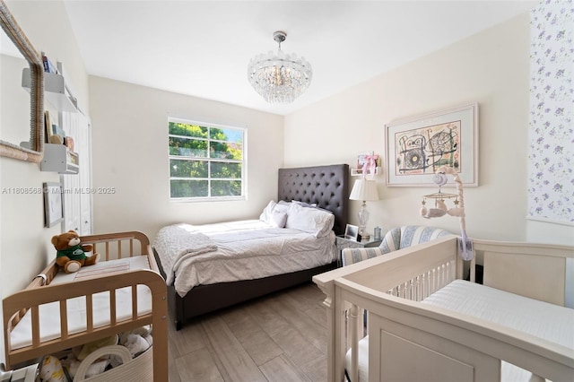 3245 NE 184th St Unit 13402, Aventura, FL 33160 - bedroom featuring a chandelier and light wood-style flooring