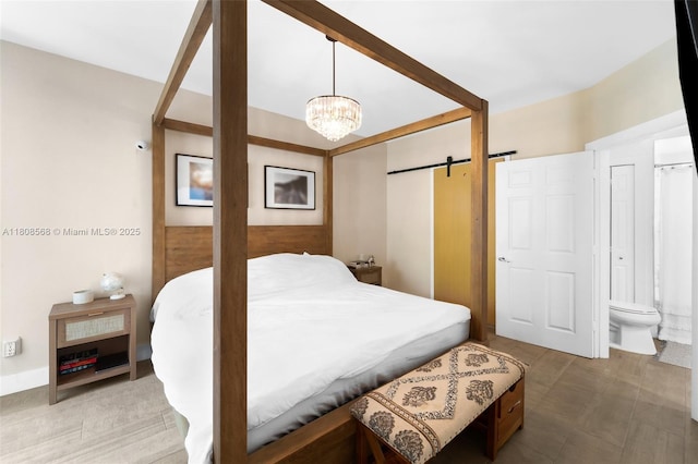 3245 NE 184th St Unit 13402, Aventura, FL 33160 - bedroom featuring a barn door, a chandelier, ensuite bath, and a closet