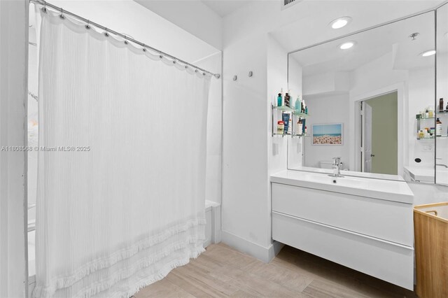 3245 NE 184th St Unit 13402, Aventura, FL 33160 - bathroom with vanity, shower / bathtub combination with curtain, wood finished floors, and recessed lighting