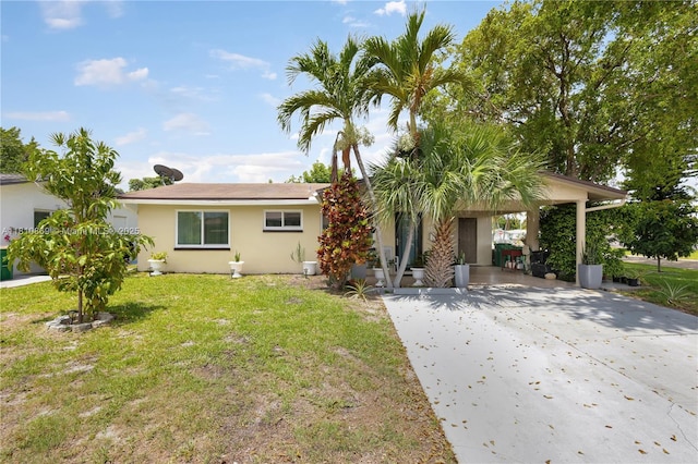 5723 NW 69th Ave, Tamarac, FL 33321 - view of front of home featuring driveway, a front lawn, stucco siding, and a carport