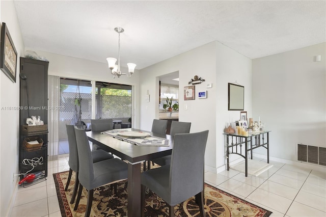 5723 NW 69th Ave, Tamarac, FL 33321 - dining room with light tile patterned floors, a chandelier, baseboards, and a textured ceiling