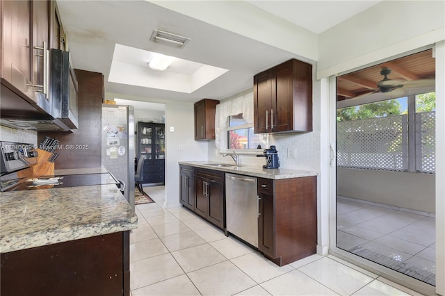 5723 NW 69th Ave, Tamarac, FL 33321 - kitchen with stainless steel appliances, a sink, ceiling fan, a tray ceiling, and dark brown cabinetry