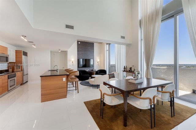 3301 NE 1st Ave Unit Ph7, Miami, FL 33137 - dining room with light tile patterned flooring and a towering ceiling