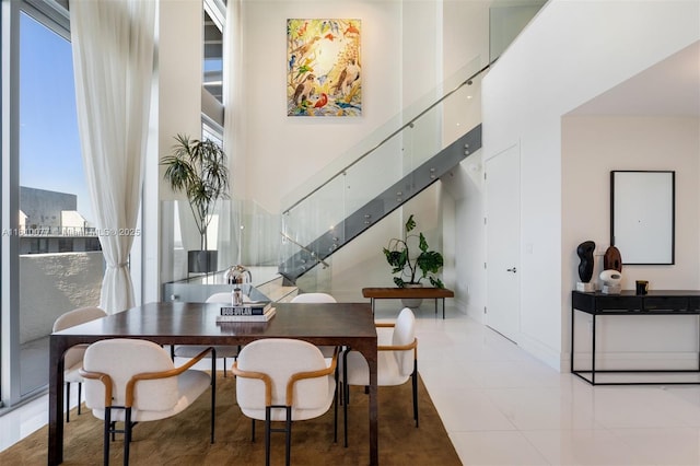 3301 NE 1st Ave Unit Ph7, Miami, FL 33137 - dining room with a towering ceiling, healthy amount of natural light, stairway, and light tile patterned floors