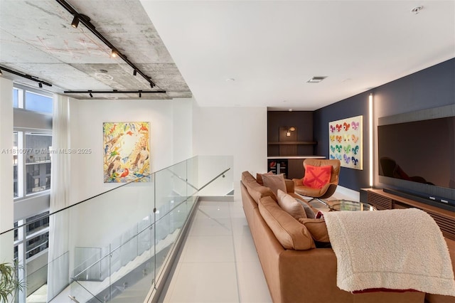 3301 NE 1st Ave Unit Ph7, Miami, FL 33137 - living room featuring track lighting, tile patterned flooring, and baseboards