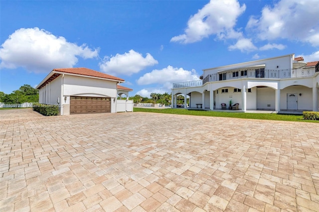 4610 SW 178th Ave, Southwest Ranches, FL 33331 - view of front of house featuring stucco siding, an attached garage, decorative driveway, and a balcony