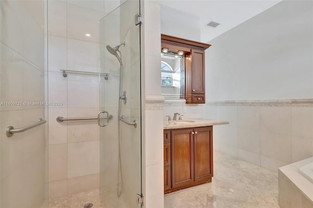 4610 SW 178th Ave, Southwest Ranches, FL 33331 - bathroom with a shower stall, vanity, tile walls, and tiled tub
