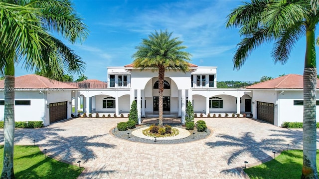 4610 SW 178th Ave, Southwest Ranches, FL 33331 - mediterranean / spanish house with french doors, an attached garage, curved driveway, and stucco siding