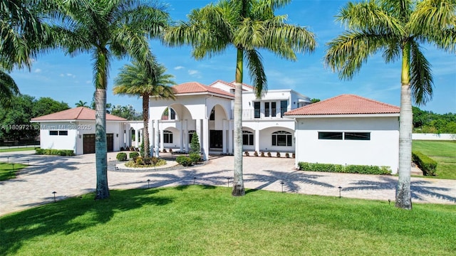4610 SW 178th Ave, Southwest Ranches, FL 33331 - mediterranean / spanish home with stucco siding, a front lawn, a tile roof, curved driveway, and a garage