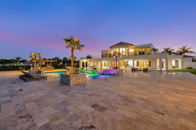 4610 SW 178th Ave, Southwest Ranches, FL 33331 - pool at dusk featuring a patio, an outdoor pool, and outdoor lounge area