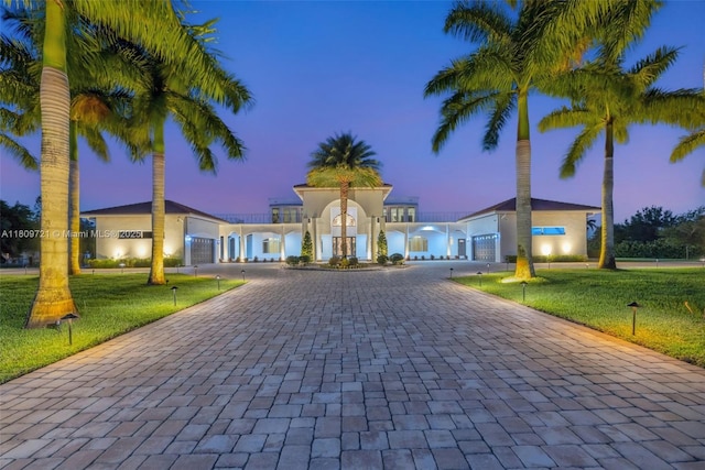 4610 SW 178th Ave, Southwest Ranches, FL 33331 - mediterranean / spanish house featuring curved driveway, a yard, and a garage