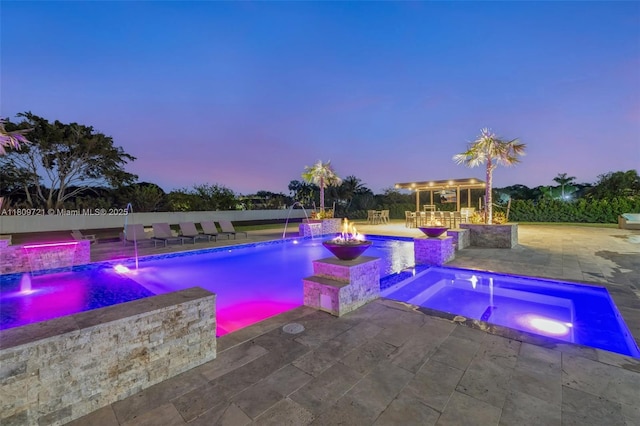 4610 SW 178th Ave, Southwest Ranches, FL 33331 - pool at dusk featuring a pool with connected hot tub and a patio