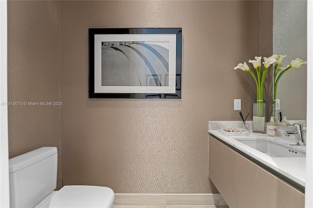 3250 NE 188th St Unit Uph08, Aventura, FL 33180 - bathroom with toilet, vanity, and a textured wall
