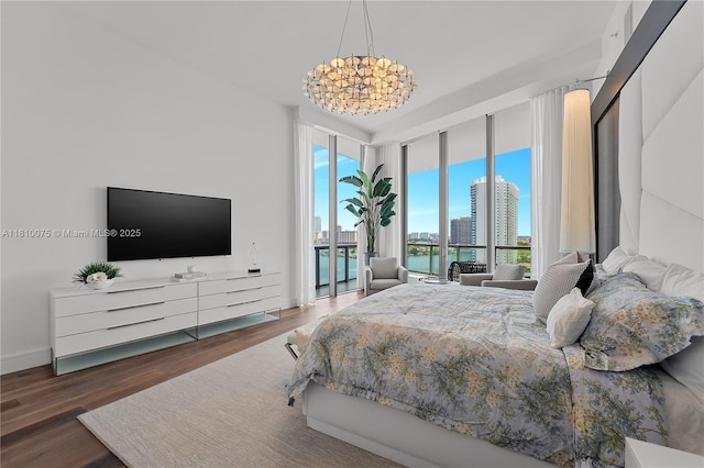 3250 NE 188th St Unit Uph08, Aventura, FL 33180 - bedroom featuring a chandelier, access to outside, a wall of windows, and wood finished floors