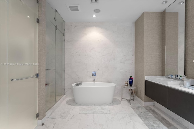 3250 NE 188th St Unit Uph08, Aventura, FL 33180 - bathroom with a freestanding bath, marble finish floors, a shower stall, tile walls, and double vanity