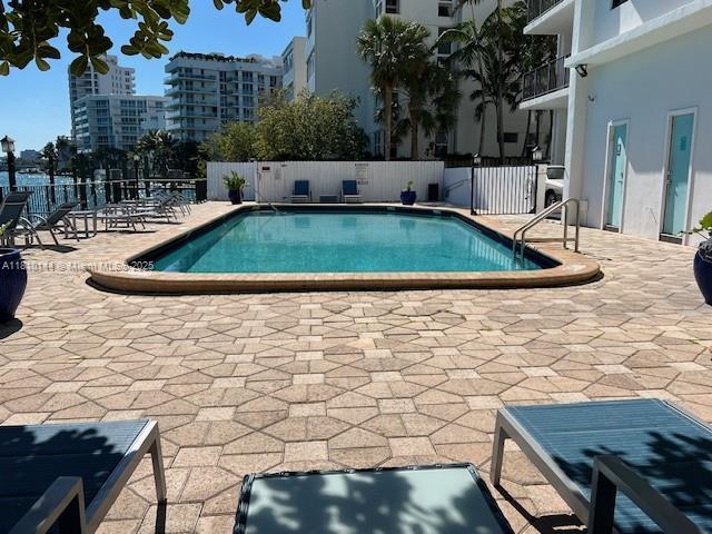 10101 E Bay Harbor Dr Unit 401, Bay Harbor Islands, FL 33154 - community pool featuring a patio area