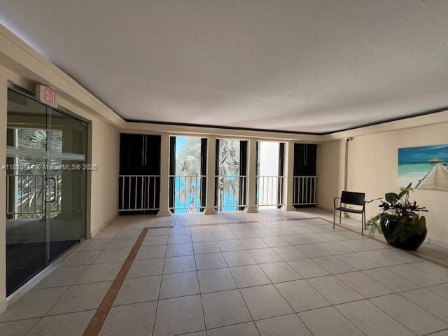 10101 E Bay Harbor Dr Unit 401, Bay Harbor Islands, FL 33154 - empty room with healthy amount of natural light and light tile patterned floors
