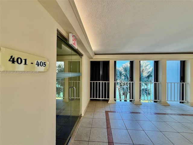 10101 E Bay Harbor Dr Unit 401, Bay Harbor Islands, FL 33154 - tiled empty room featuring a textured ceiling and ornate columns