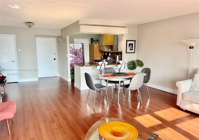 10101 E Bay Harbor Dr Unit 401, Bay Harbor Islands, FL 33154 - dining area with wood finished floors and a textured ceiling