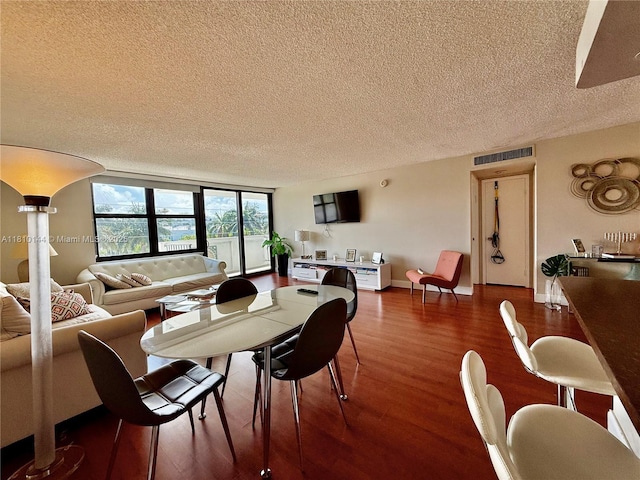 10101 E Bay Harbor Dr Unit 401, Bay Harbor Islands, FL 33154 - dining space featuring a textured ceiling and dark wood-style floors