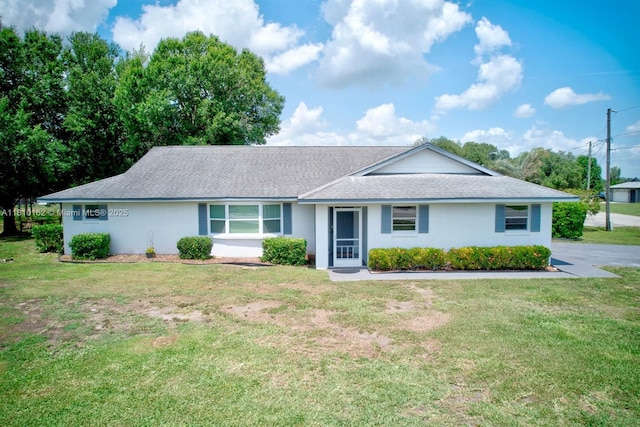 100 Honeysuckle Ln, Lake Placid, FL 33852 - single story home featuring a front yard, a shingled roof, and stucco siding