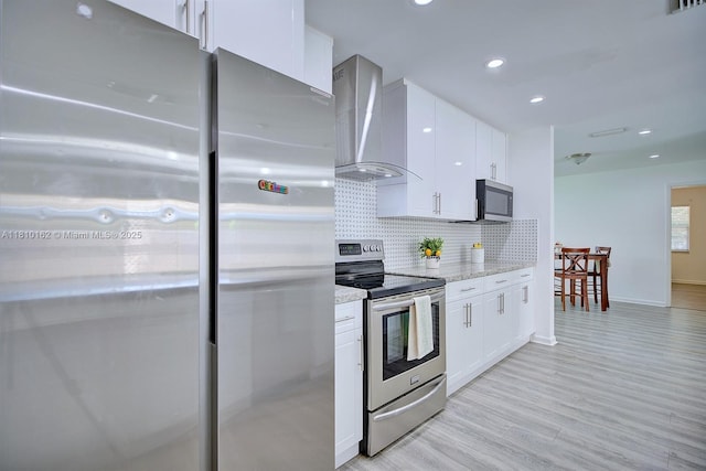 100 Honeysuckle Ln, Lake Placid, FL 33852 - kitchen featuring appliances with stainless steel finishes, wall chimney exhaust hood, white cabinets, backsplash, and recessed lighting