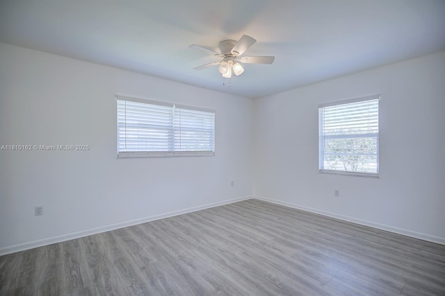 100 Honeysuckle Ln, Lake Placid, FL 33852 - empty room with plenty of natural light, wood finished floors, and a ceiling fan