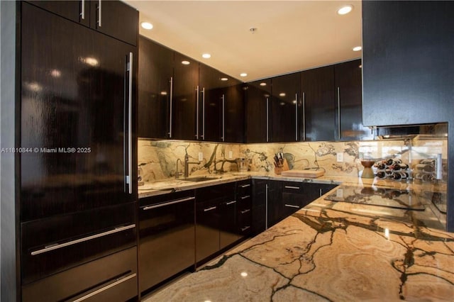 100 Lincoln Rd Unit 647, Miami Beach, FL 33139 - kitchen featuring a sink, light stone counters, modern cabinets, decorative backsplash, and recessed lighting